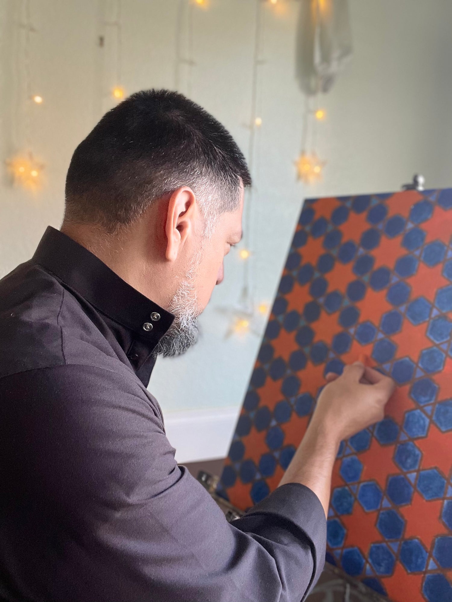 Basilio Aguirre working on a tile pattern piece
